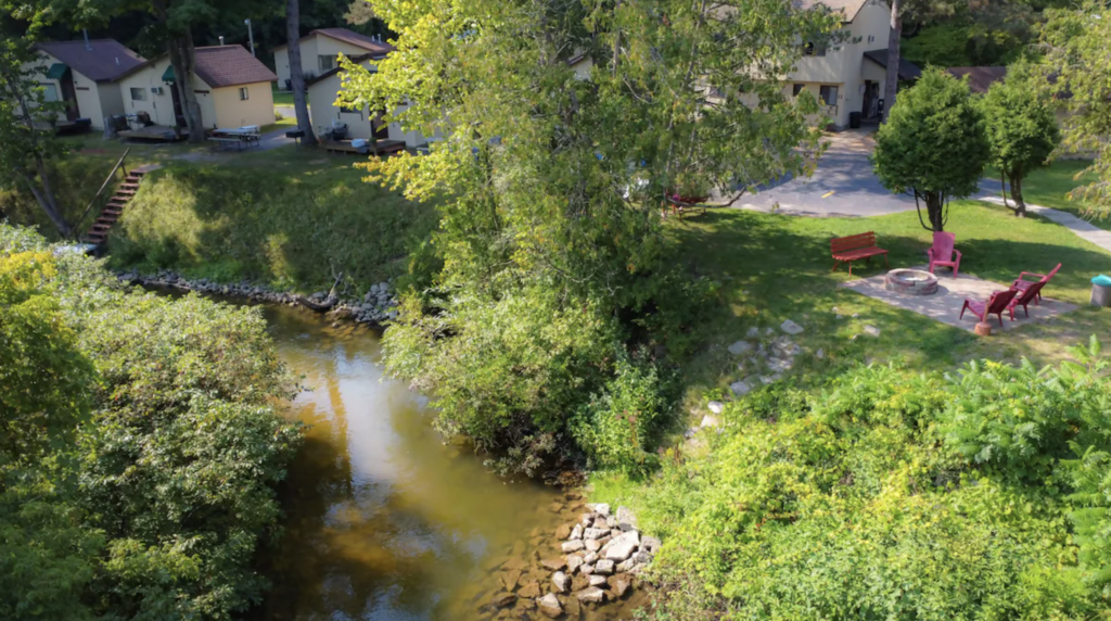 Aerial view of cozy cabins along the Betsie River. 