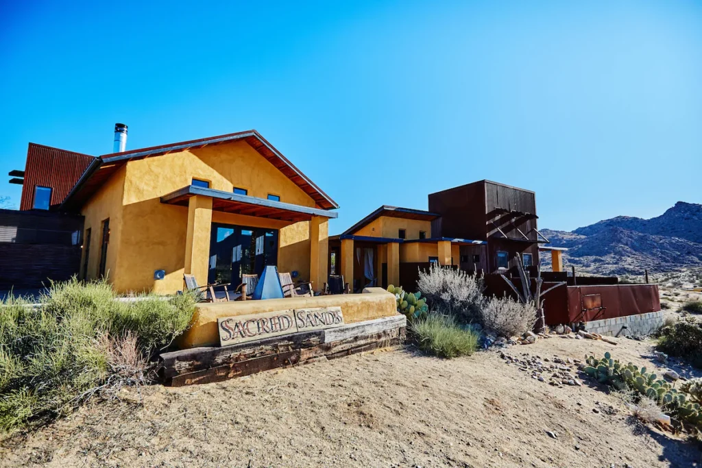 Sacred Sands. Modern desert home with large windows and stunning views.